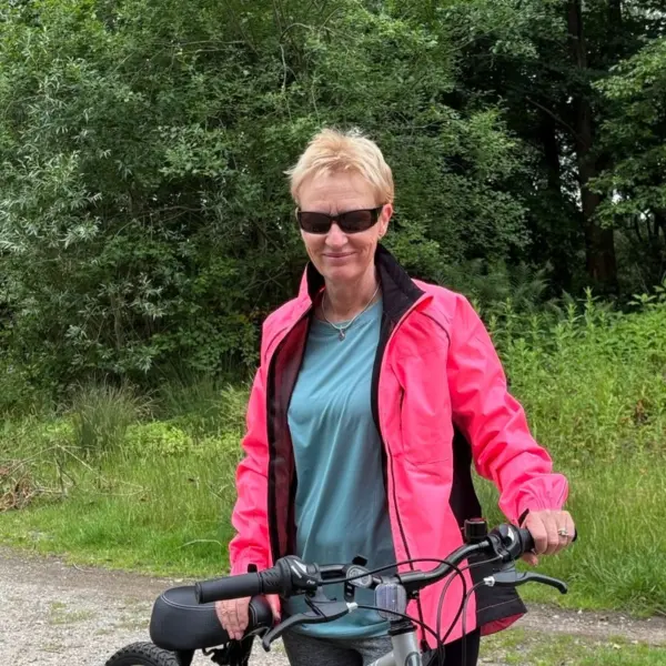 flourish foster parent lorraine posing with her bike